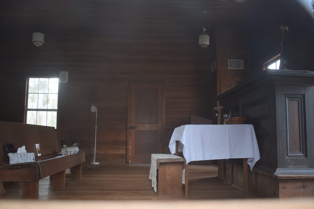 Wooden interior, pews, altar and pulpit inside historic Falling Creek Methodist Church near Lake City, Florida