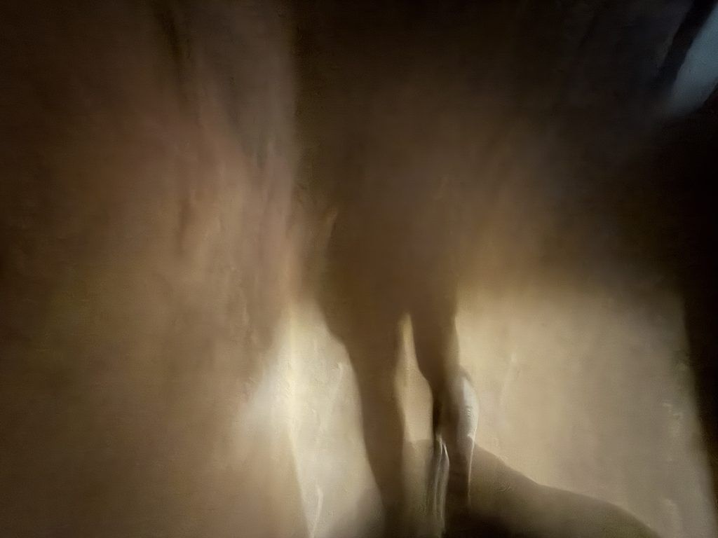 Eerie, blurred photograph of dark shadows cast against the illuminated walls of an underground dungeon at the Old Franklin County Jail in Chambersburg, Pennsylvania.