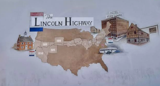 Illustrated Lincoln Highway map featuring a United States silhouette, historic roadside buildings, vintage vehicles, and the Hotel Yorktowne.
