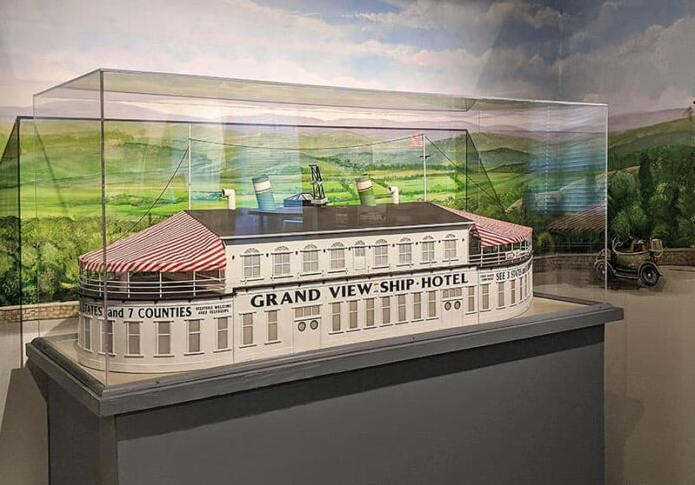 Detailed scale model of Pennsylvania's Grand View Ship Hotel displayed in a glass case, showing its ocean-liner design, twin smokestacks, observation decks, and striped awnings.