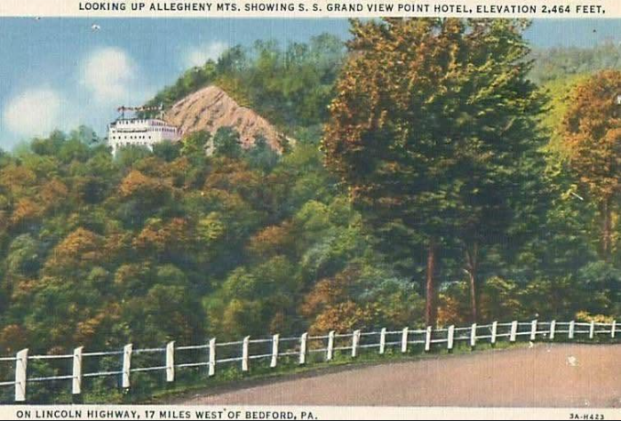 Vintage color postcard showing the Grand View Ship Hotel perched high on a rocky mountainside above the forested Alleghenies, viewed from the Lincoln Highway below.